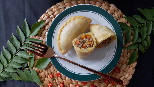 Empanada or Panada, Indonesian traditional snack from Manado, North Sulawesi. Enriched with filled with shredded smoke skipjack tuna fish at the inside. Selective focus.
