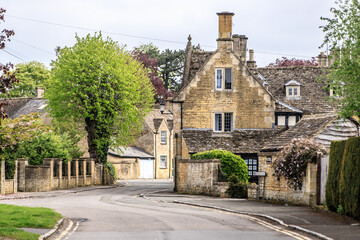 Fototapeta na wymiar The Honey-hued Streets in a Peaceful Morning in Bourton-on-the-Water, Cotswolds