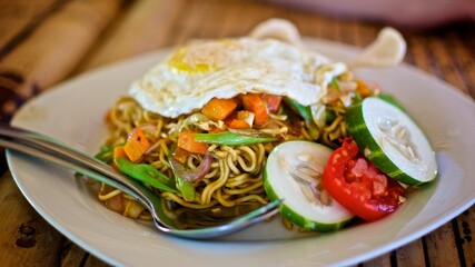 Nasi goreng Indonesian local food fried noodles with vegetables, chicken and fried eggs
