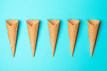 Various ice cream cones on blue background. Minimal summer concept.