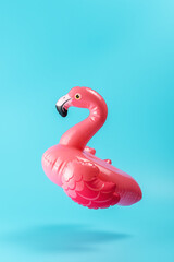 Inflatable pool toy flamingo on a blue background. Minimal summer concept. © Paopano