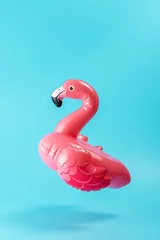 Gardinen Inflatable pool toy flamingo on a blue background. Minimal summer concept. © Paopano