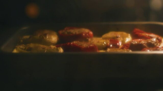 Vegetable and meat casserole. Outside view through the steamy oven door.