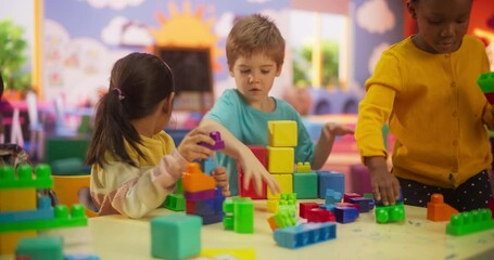 Creative Multiethnic Friends Playing in Kindergarten. International Boys and Girls Constructing a House Out of Colorful Building Blocks. Children Having Fun in Modern Daycare Center
