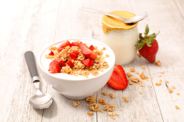 granola with nuts, strawberry and yogurt in a bowl- breakfast, health food