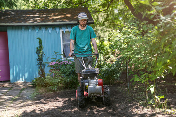 Man working with motor cultivator in his vegetable garden
