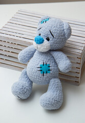 blue teddy bear toy in a white box