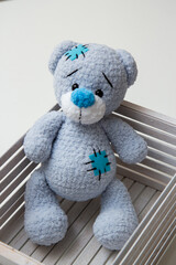 blue teddy bear toy in a white box
