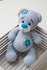 blue teddy bear toy in a white box
