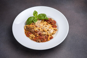 Pasta with bolognese sauce, parmesan and basil