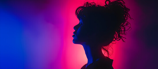 Silhouette of Young Woman against Vibrant Neon Lights
