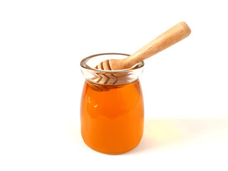 A jar of honey with a honey dipper