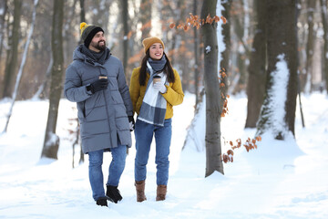 Fototapeta na wymiar Beautiful young couple enjoying winter day outdoors