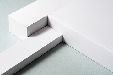 White layered pedestal, boxes on gray background