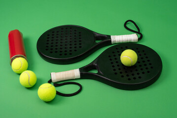 Isolated on green paddle tennis racket and balls, sports objects