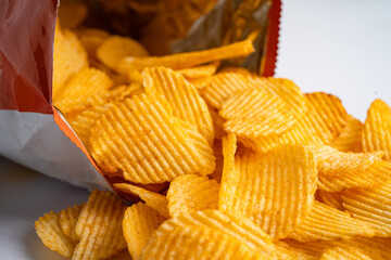 Potato chips, delicious BBQ seasoning spicy for crips, thin slice deep fried snack fast food in open bag.