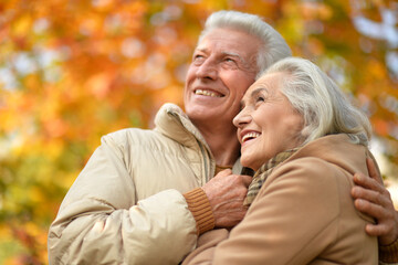 Fototapeta premium Portrait of happy senior couple in autumn park