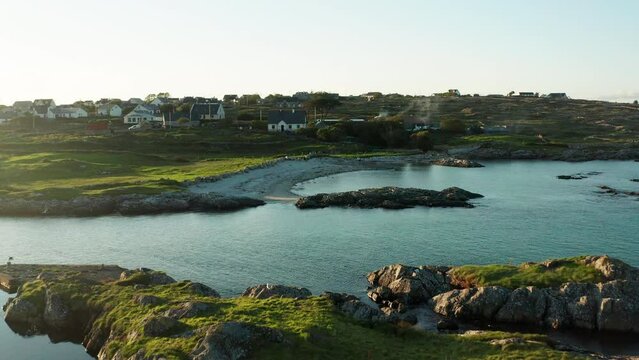 Embark on a visual journey through Connemara, Galway, Ireland, with a compelling drone push shot capturing the lush green landscape and the serene beauty of its coastal beaches.