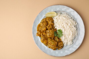 Delicious chicken curry with rice on beige background, top view. Space for text
