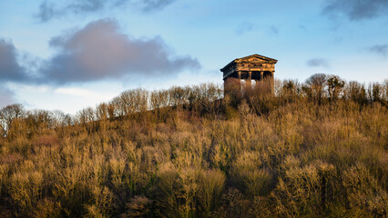 Penshaw Monument above Penshaw Wood.  Penshaw Monument is a copy of the Greek Temple of Hephaestus in Athens. Erected in 1844 the folly stands 20 metres high and dominates the skyline of Wearside - obrazy, fototapety, plakaty
