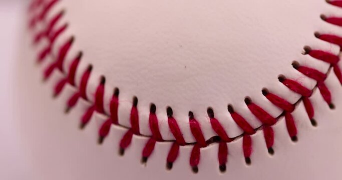 white baseball ball tied with red thread, a real round baseball ball close-up