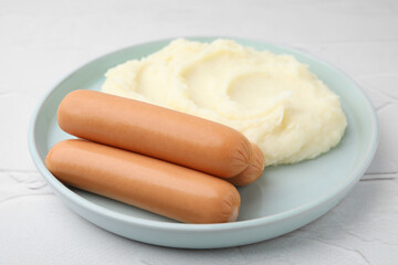 Fototapeta na wymiar Delicious boiled sausages and mashed potato on white textured table, closeup