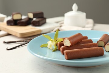 Glazed vanilla curd cheese bars served on white wooden table, closeup