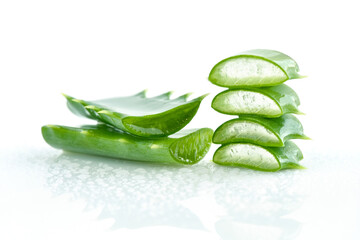 Fresh aloe vera leaves and slices on with white background with water droplets. For Health and beauty products.