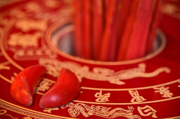 A close shot of divination blocks and fortune sticks that are used for advice from God.