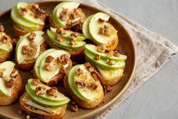 Fototapeta premium Homemade Apple Brie Crostinis on a Plate, side view. Close-up.