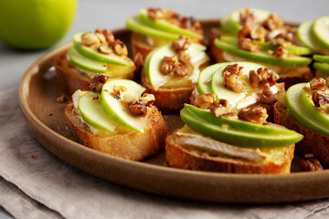 Homemade Apple Brie Crostinis on a Plate, low angle view. Close-up.