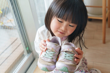 古い靴を持った子供