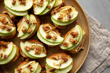 Homemade Apple Brie Crostinis on a Plate, top view. Flat lay, overhead, from above.