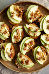 Homemade Apple Brie Crostinis on a Plate, top view. Flat lay, overhead, from above.