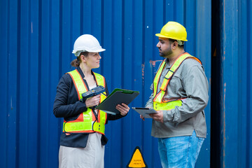 Warehouse engineer inspects the inside of a container with a customer at an industrial container yard.