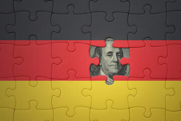 puzzle with the national flag of germany and usa dollar banknote. finance concept