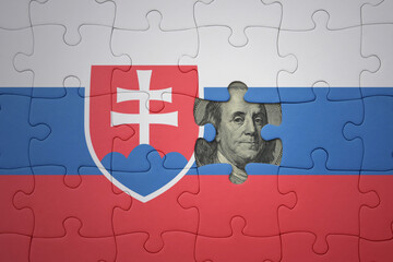 puzzle with the national flag of slovakia and usa dollar banknote. finance concept