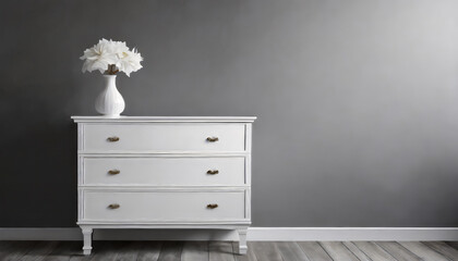 White chest of drawers near grey wall with copy space