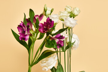 object photo of unique blooming lilies and eustoma flowers on pastel yellow background, nobody