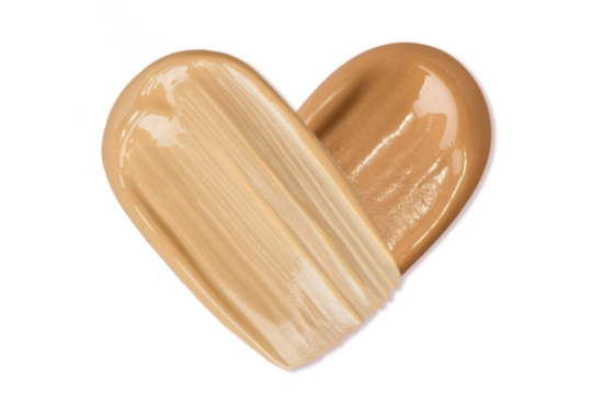 Smears of foundation in the shape of a heart on a blank background
