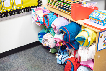 Top view school storage cabinet full of rolled toddler nap mats at preschool kindergarten in...