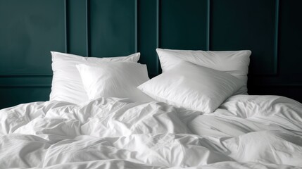 a bed white comforter and two pillows and a headboard green headboard behind it.