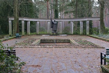 Fototapeta premium Potsdam, Germany - Jan 23, 2024: This Red Army war cemetery contains the graves of 2398 Soviet soldiers who were killed in 1945 during Second World War. Cloudy winter day. Selective focus