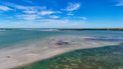 An original drone photograph of a low tide sand bar and seagulls in the water, west coast Florida