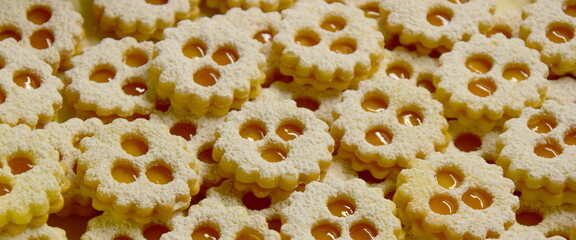 Christmas biscuits baking, rogues, shortcrust pastry biscuits sprinkled with jam and icing sugar, Christmas background