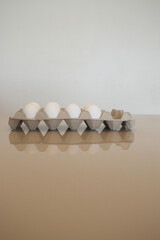 a small box of farm eggs on a table
