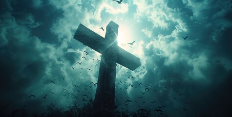 a cross with several birds flying above