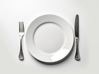 A White Plate With a Knife and Fork