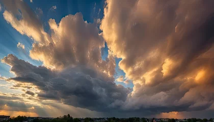 Zelfklevend Fotobehang sun rays through the clouds, sunset, golden hour, blue sky with clouds, clouds in the sky, panoramic view of clouds, cloud background © Gegham