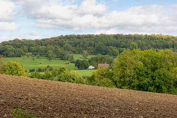 Fototapeta na wymiar Summer landscape view, Hilly countryside of Zuid-Limburg with small villages on the hillside, farmland and forest, Epen is a village in the southern part of the Dutch province of Limburg, Netherlands.